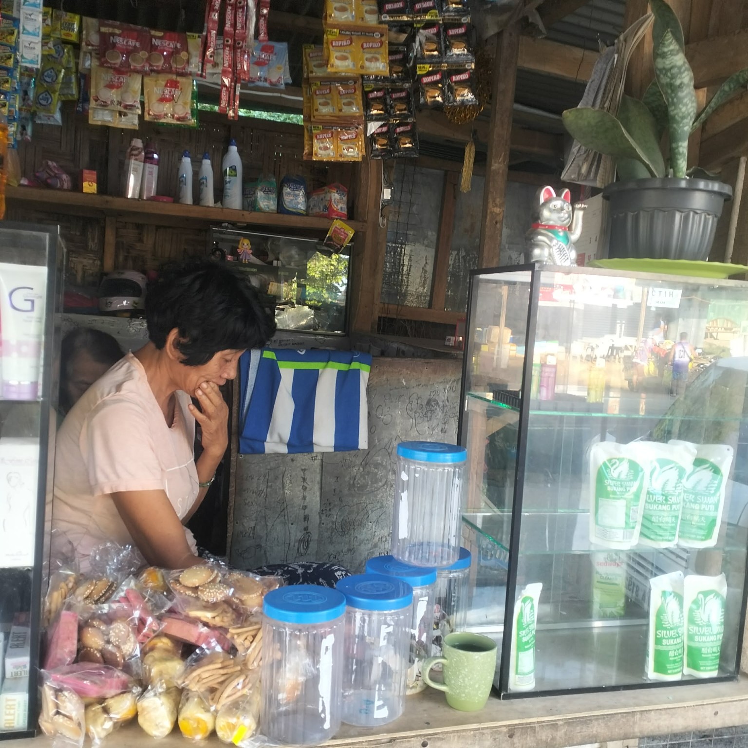 Leni working inside her neighborhood sari-sari store